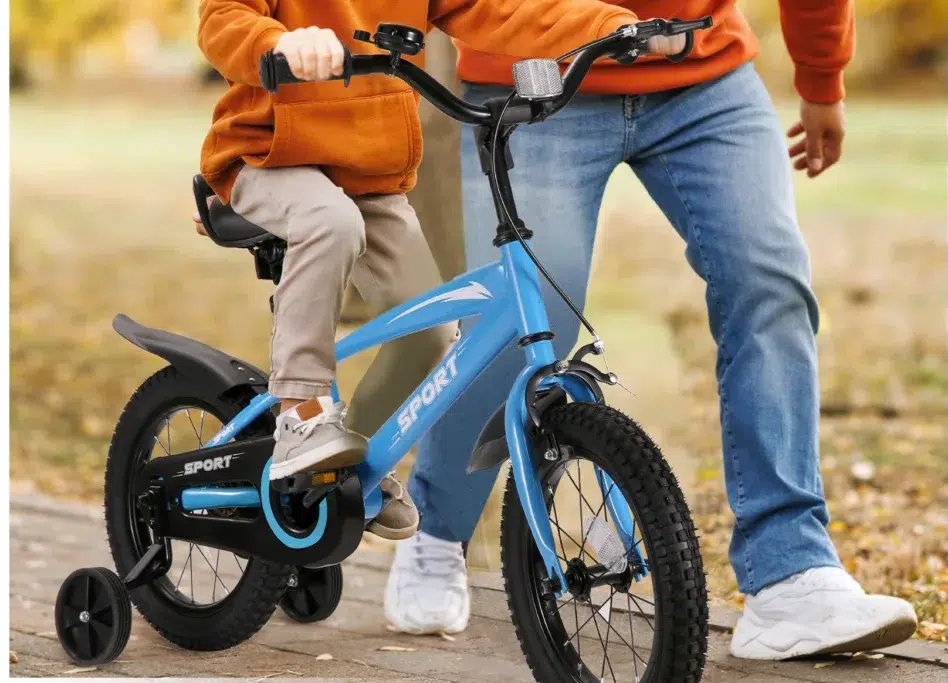 Child riding blue bicycle with adult support.