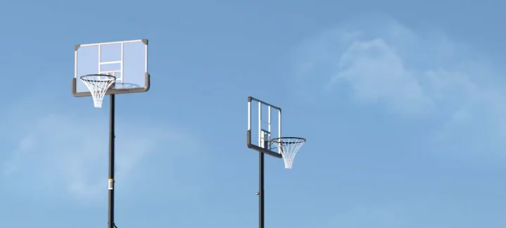 Two basketball hoops against a blue sky.