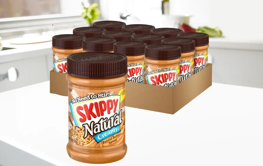 Natural creamy peanut butter jars on kitchen counter.