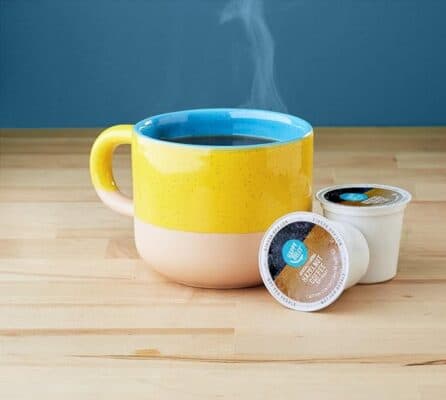 Colorful mug with coffee and coffee pods