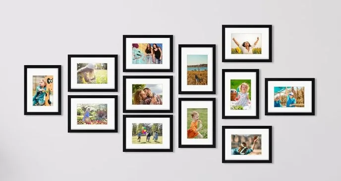 Collage of framed family and nature photos on wall.