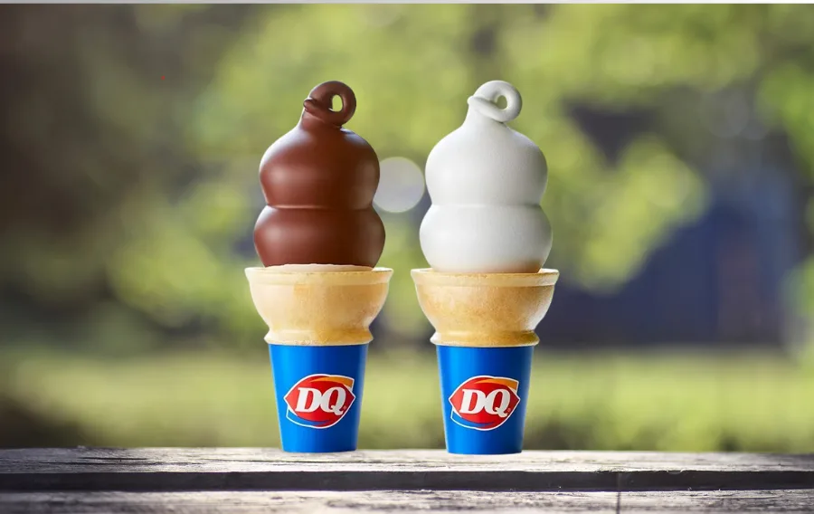 Chocolate and vanilla soft serve cones outdoors.