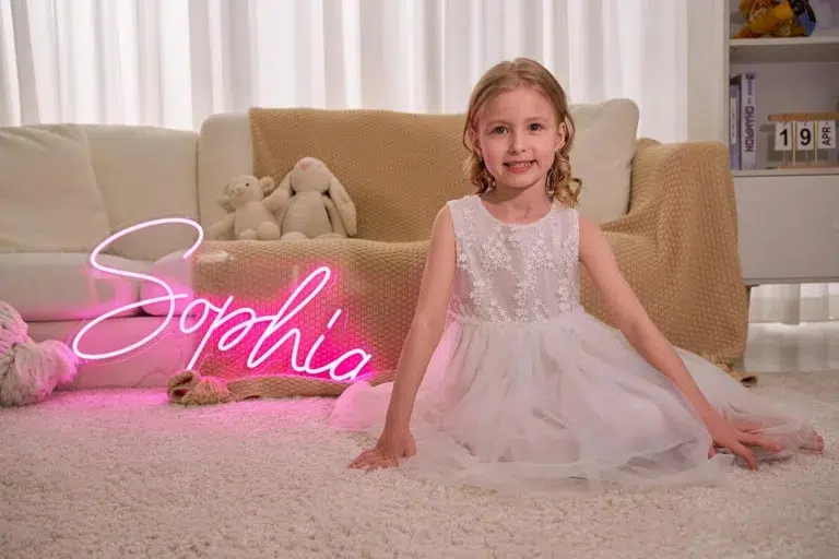 Girl in white dress with pink neon sign