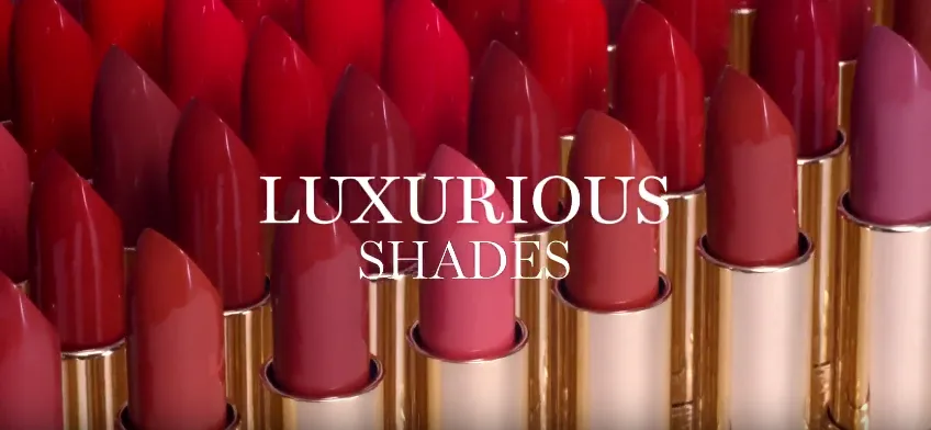 Various luxurious lipstick shades in gold tubes.