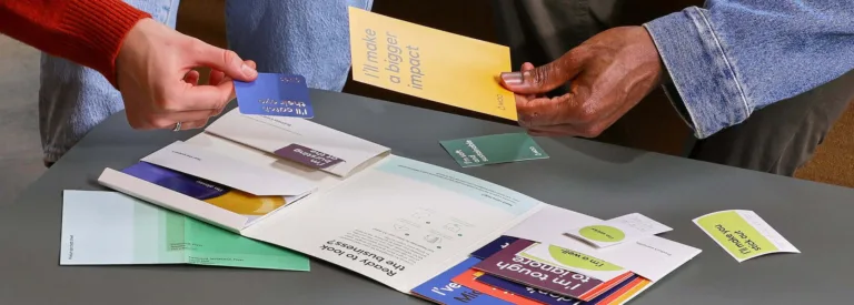 Two people examining colorful print materials