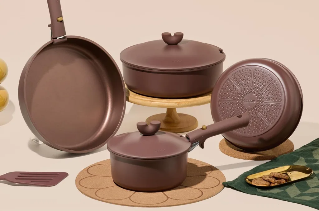 Nonstick brown cookware set with lids and spatula.