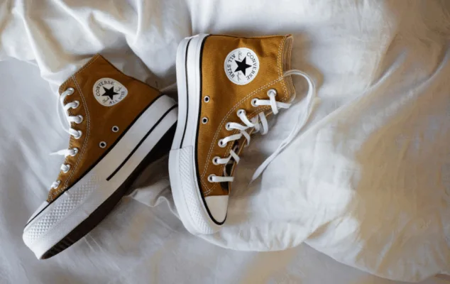 Brown Converse sneakers on white sheet