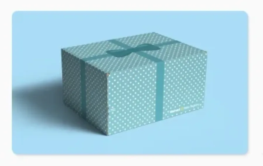 Polka dot gift box with ribbon on blue background.