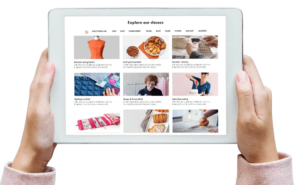 Hands holding tablet displaying online classes