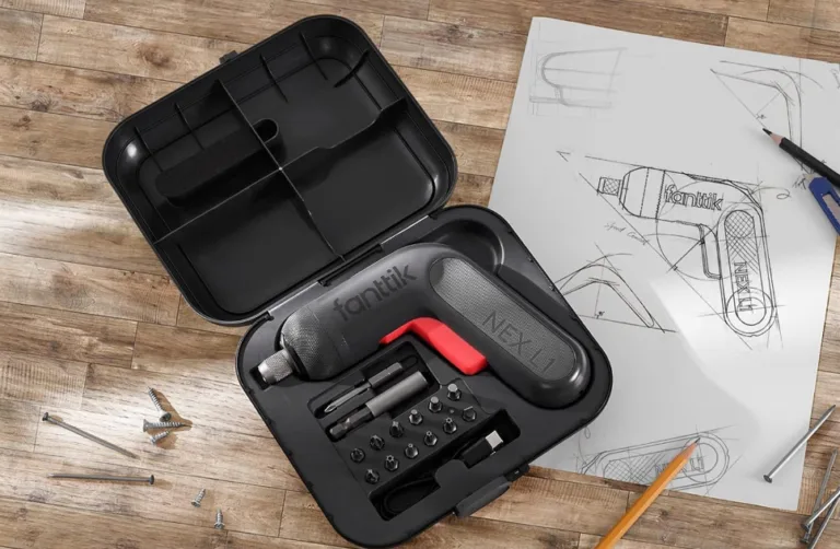 Cordless drill set with design sketches on table.