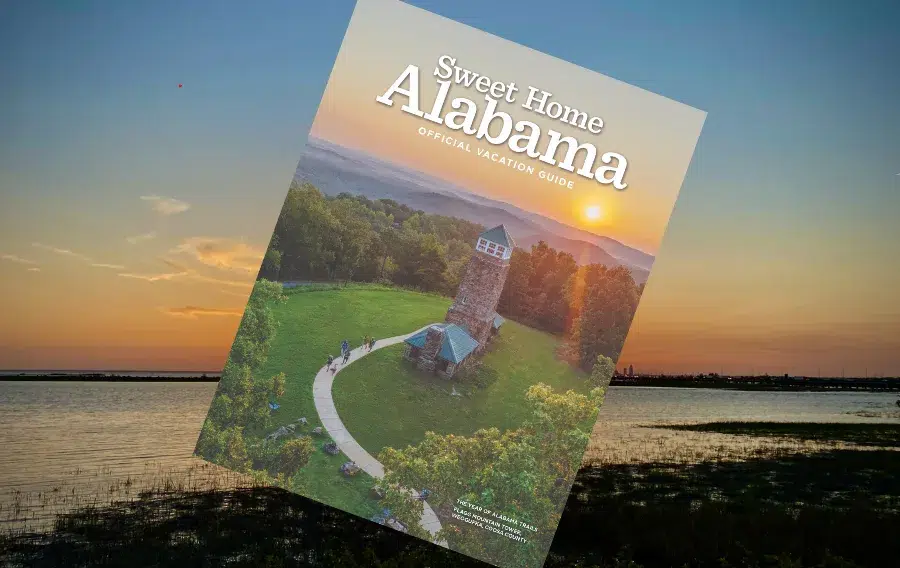 Alabama vacation guide cover with sunset view.