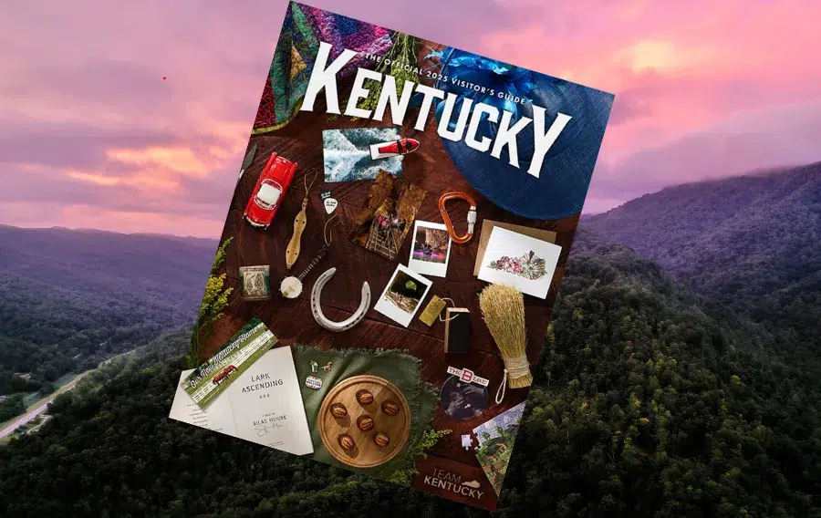 Kentucky visitor guide with scenic mountain background.