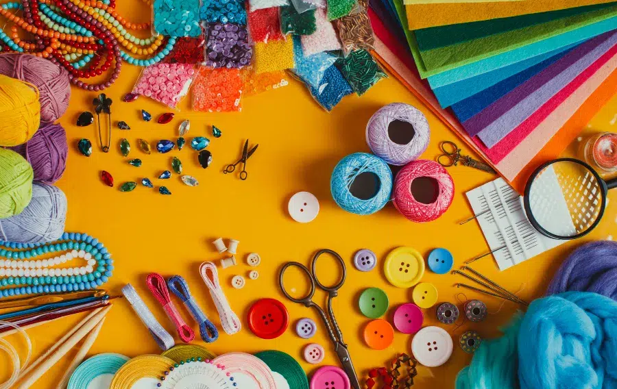 Colorful craft supplies on a yellow background