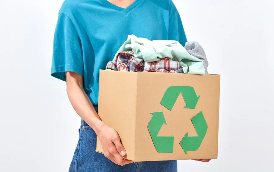 Person holding recycled clothes box