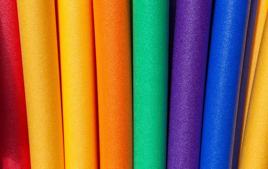Colorful rolls of textured paper standing upright.