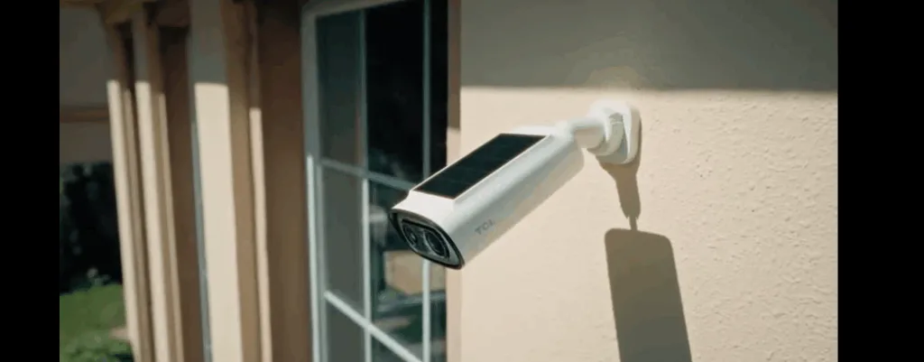 Outdoor solar security camera on house wall.