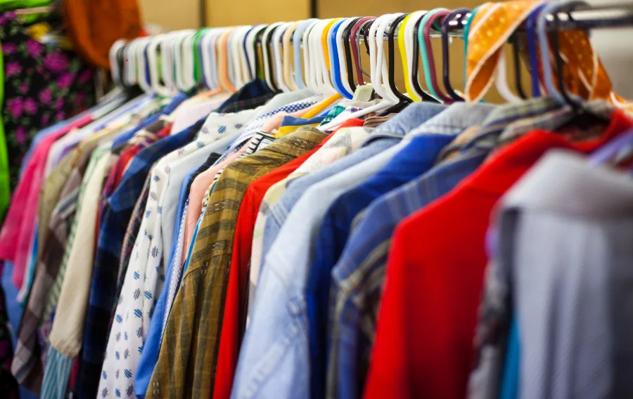 Colorful clothes hanging on a rack.