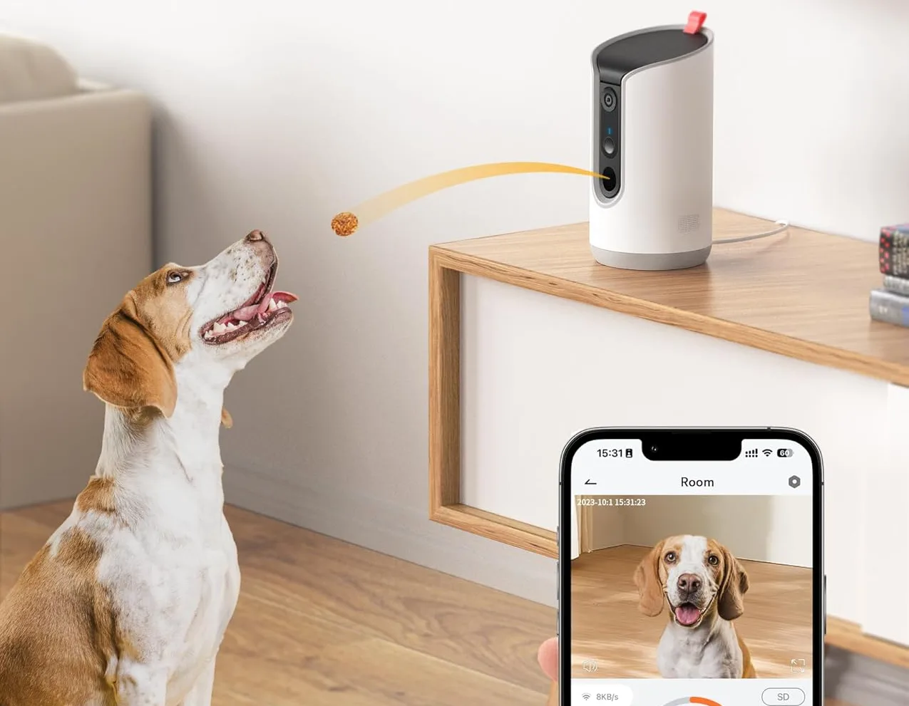 Dog eagerly awaits treat from dispenser and phone view.
