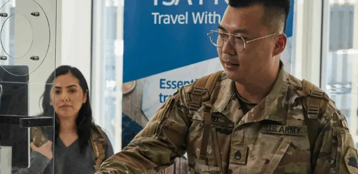 Military personnel at travel information booth.