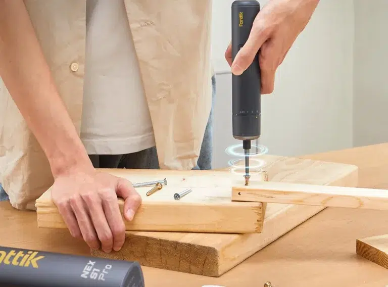Person using electric screwdriver on wood project