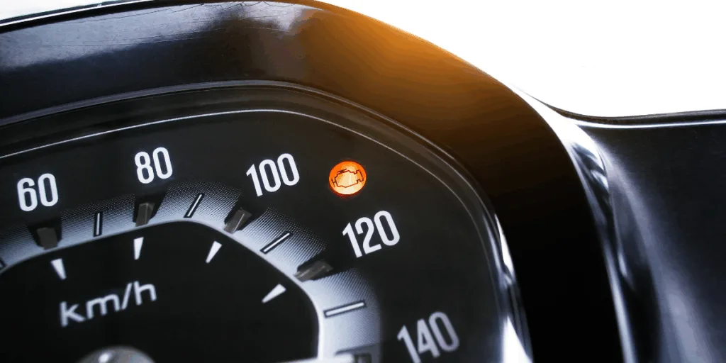 Car dashboard with check engine light illuminated