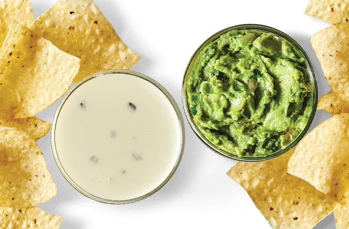 Tortilla chips with queso and guacamole dip