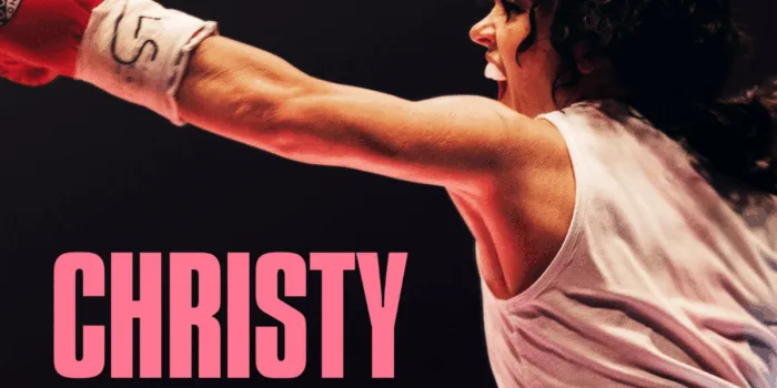 Female boxer throws punch in ring.