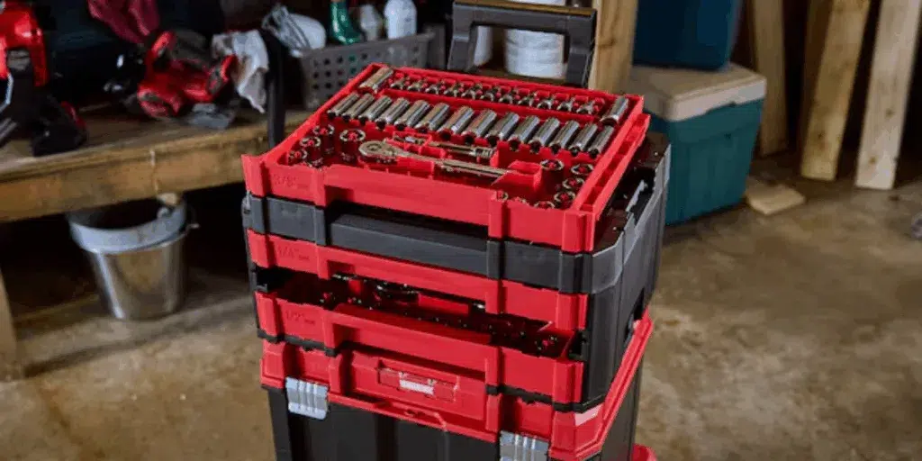 Red portable tool chest in garage workshop.