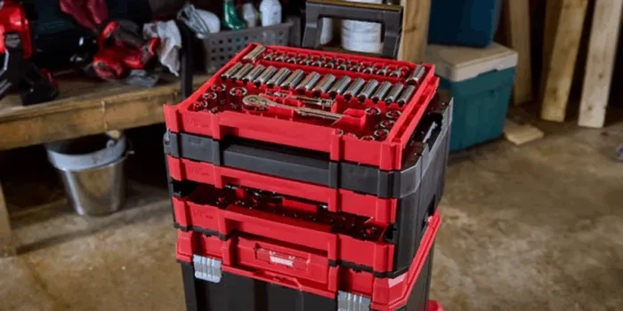 Red portable tool chest in garage workshop.