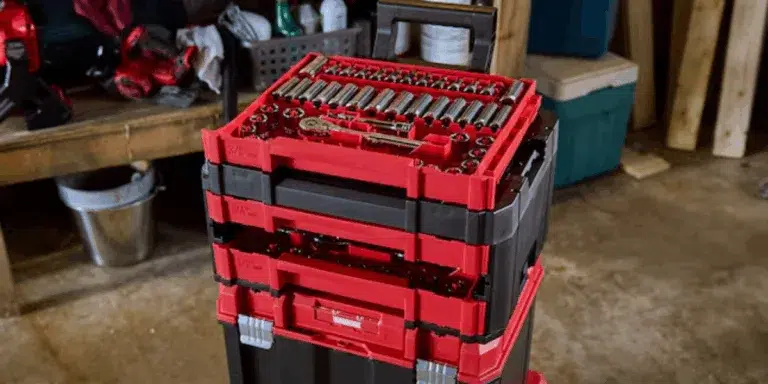 Red portable tool chest in garage workshop.