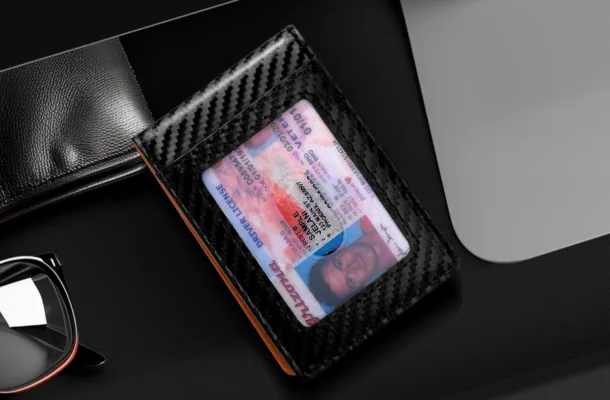 Driver's license in carbon-fiber wallet with sunglasses.