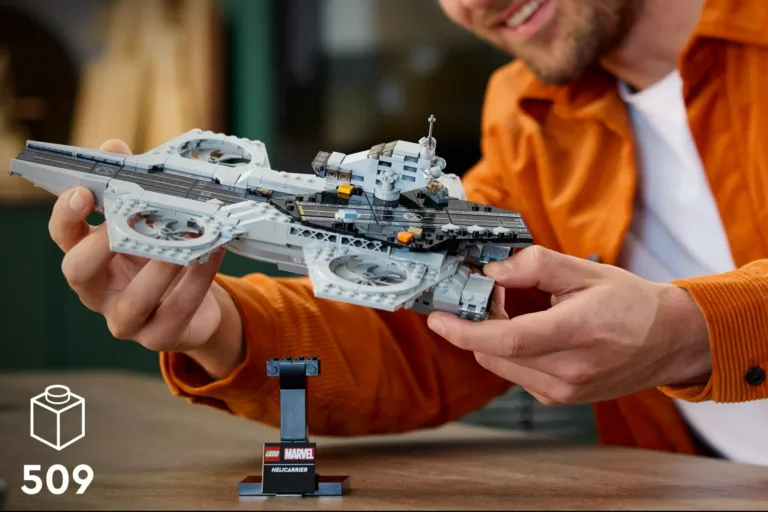 Person holding LEGO Marvel Helicarrier model.