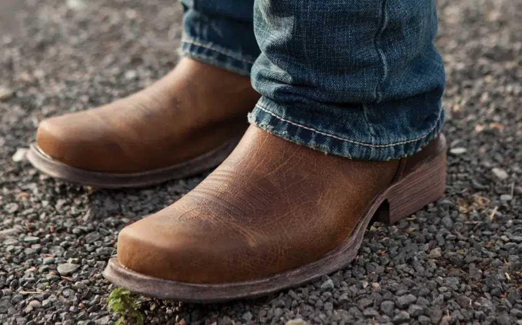 Brown leather shoes on gravel path