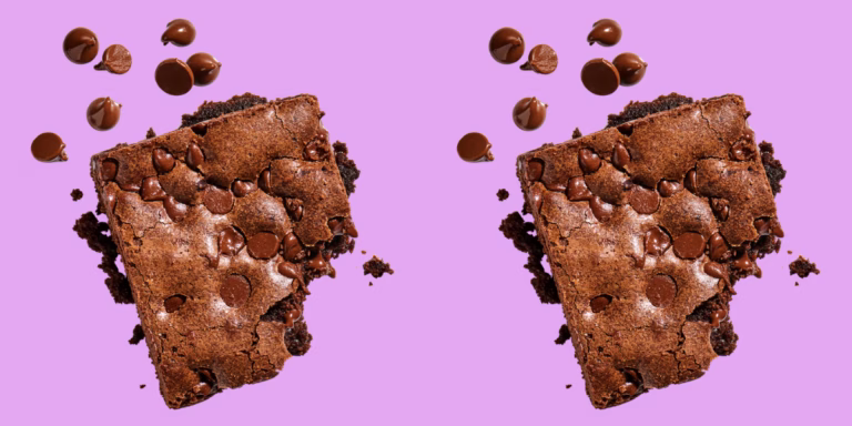 Two chocolate brownies with chips on purple background.