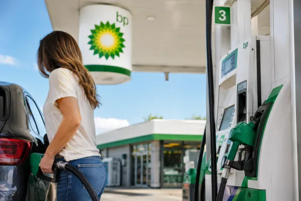 bp filling up car at station gas